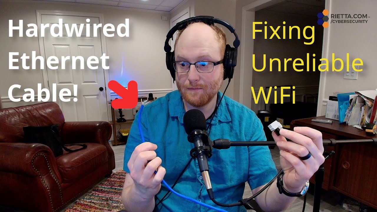 Frank Rietta holding an Ethernet cable and connector, with on-screen text "Hardwired Ethernet Cable!" and "Fixing Unreliable WiFi."